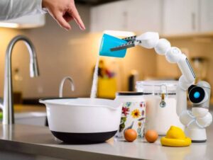A robotic arm pours sugar into a white bowl on a kitchen counter, surrounded by eggs, a lemon, and various containers.