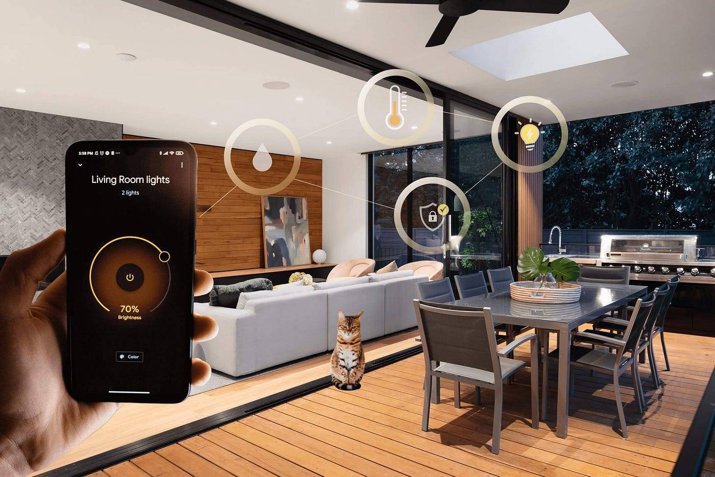 An elegant living room with a large sofa and art on the walls, which connects to a dining area with a stylish outdoor kitchen