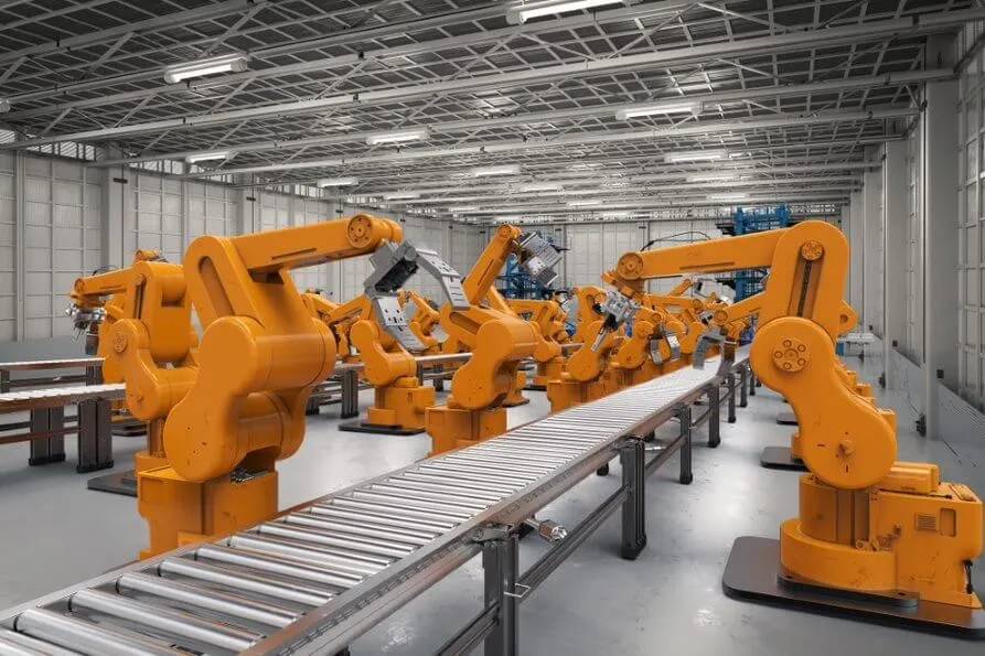 A factory floor featuring multiple orange robotic arms aligned alongside a conveyor belt in a spacious industrial setting.