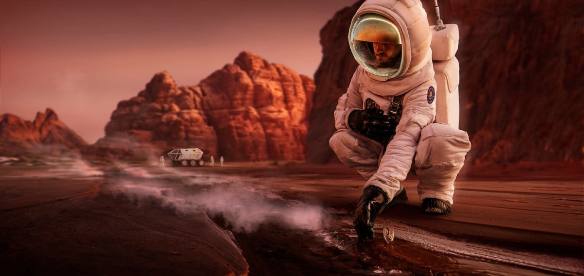 An astronaut crouches on the rocky surface of Mars, examining steam rising from a fissure, with a rover in the background.