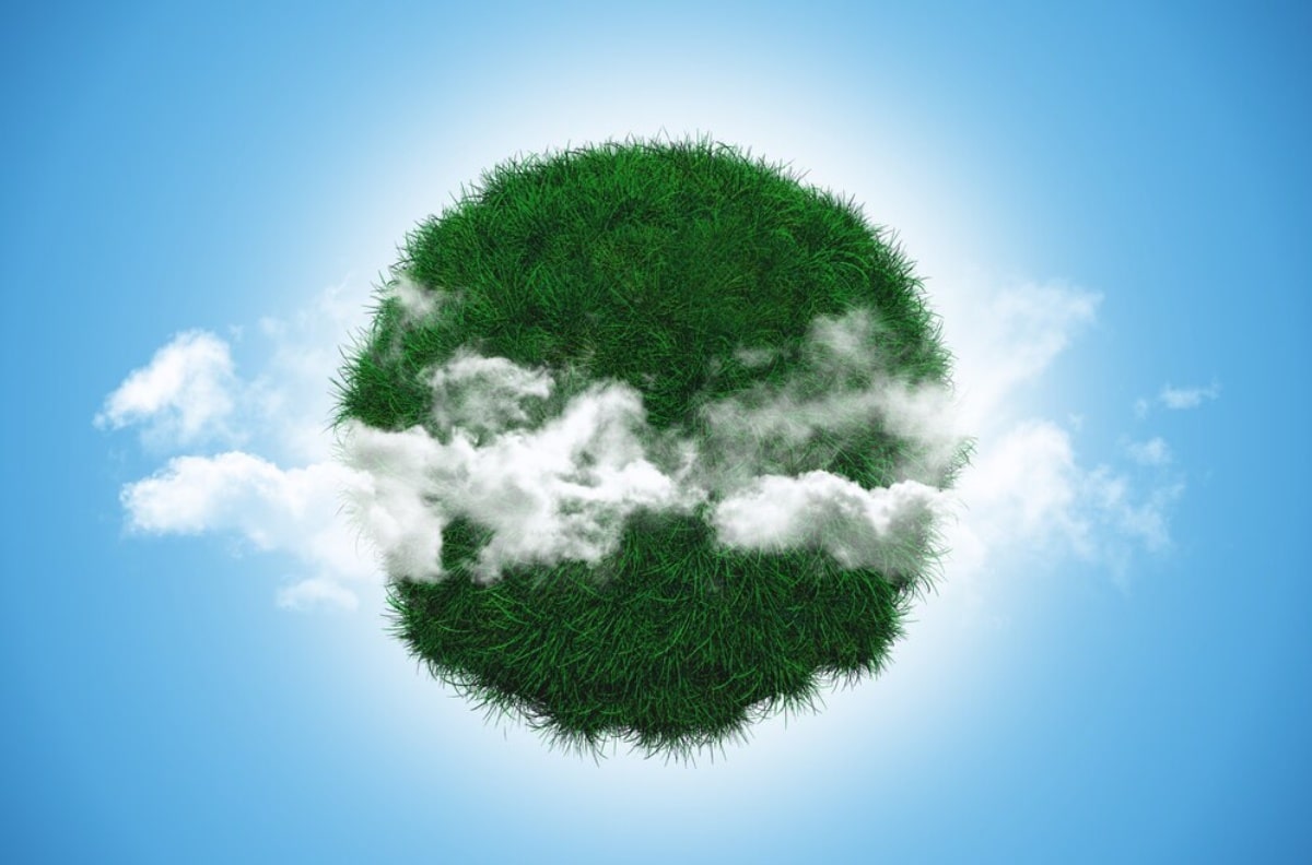 A green grass-covered ball featuring soft, white clouds scattered across its exterior.