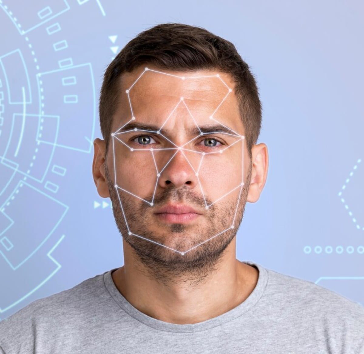 A man wearing a face mask stands in front of a facial recognition system, highlighting technology and health safety measures.