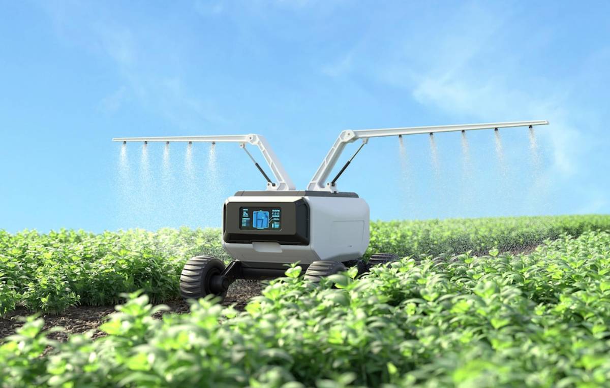  A robot spraying water over a green field, demonstrating automated irrigation technology in agriculture.
